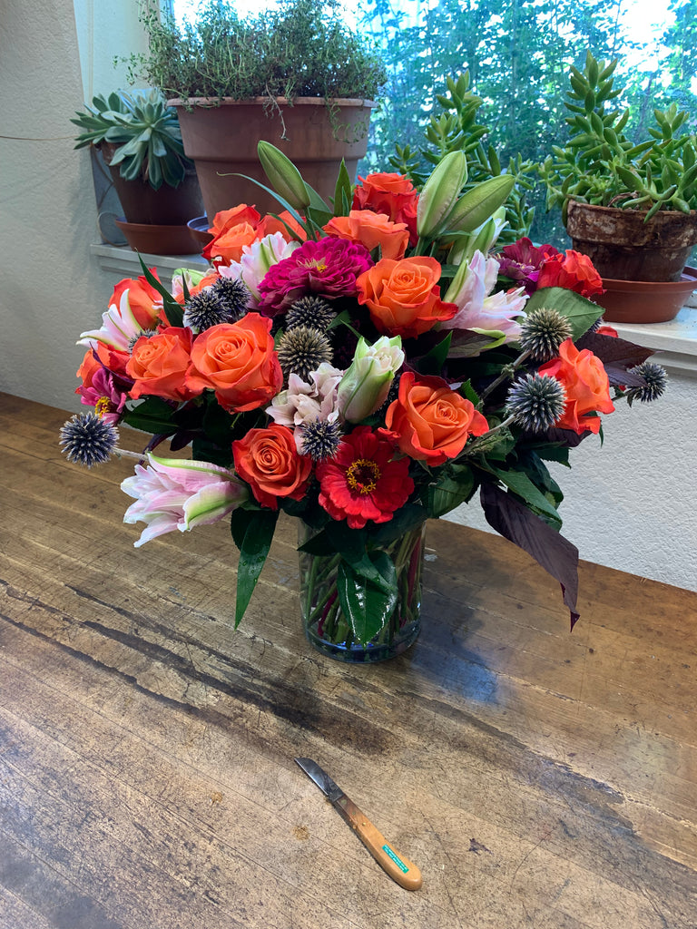 Lush and full cut flower arrangement in a 6x8 inch Cylinder Vase with Colorado greenhouse and field grown flowers and South American Roses